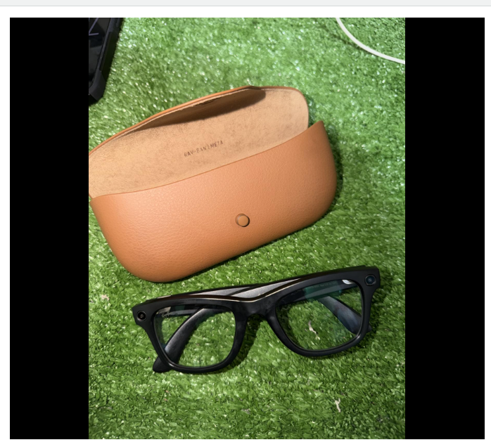 Ray-Ban Meta smart glasses and leather case on white surface